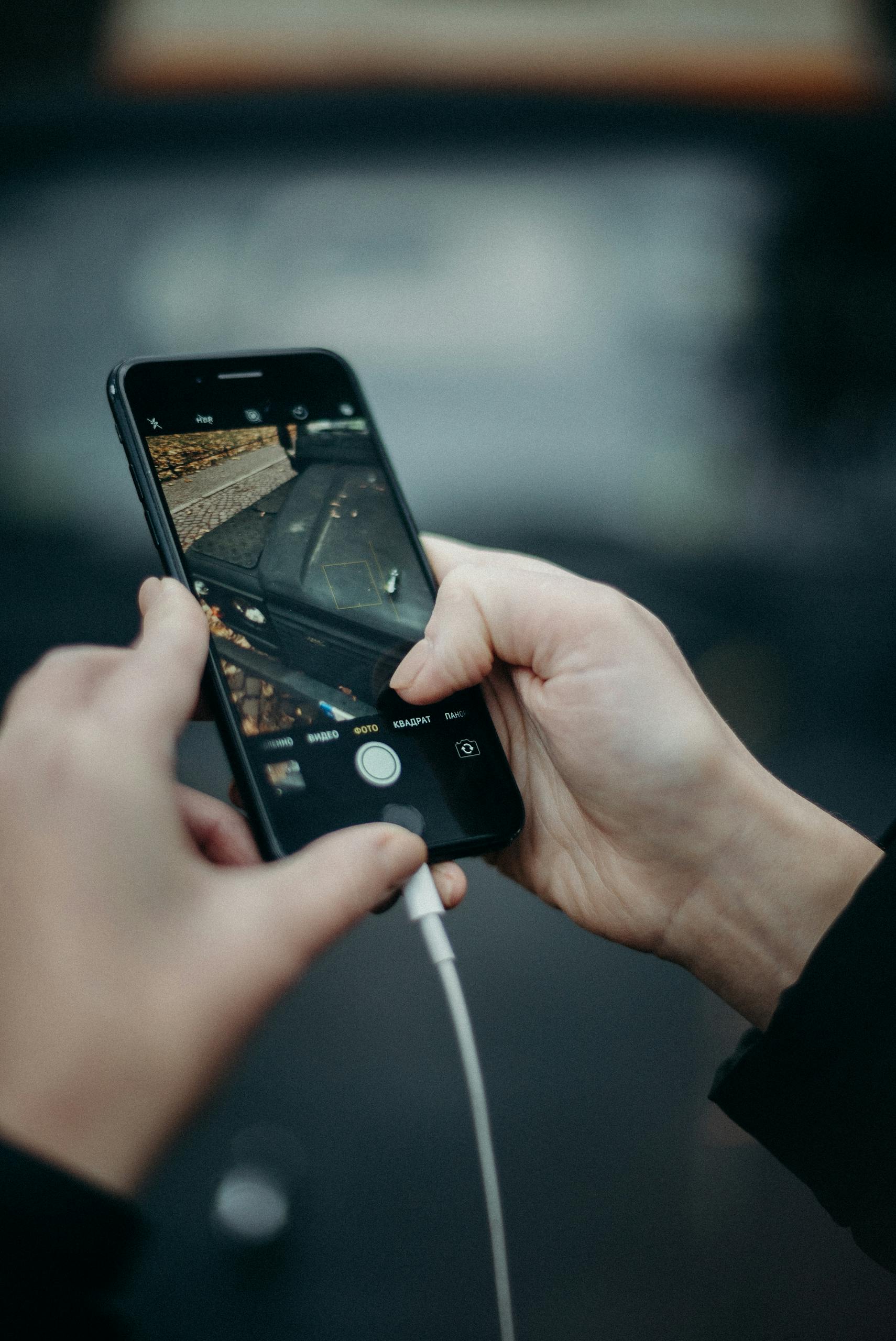 Person Holding Black Iphone 4